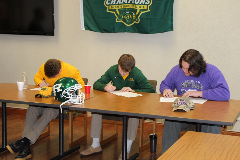 Regis High School football players sign National Letters of Intent